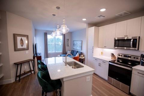 a kitchen and living room with a white counter top