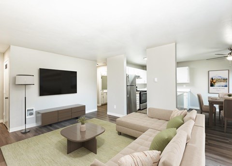 A living room with a brown coffee table and a large sectional sofa.