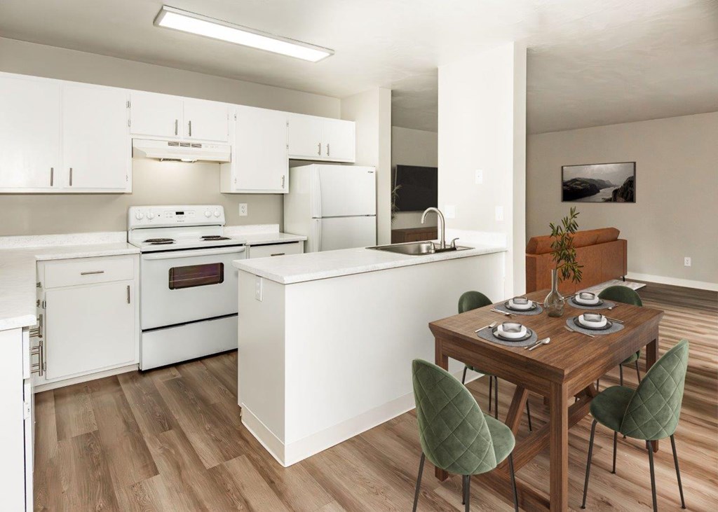 A kitchen with white appliances and a wooden table with green chairs.