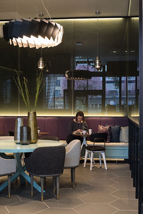 a woman sitting at a table in a restaurant