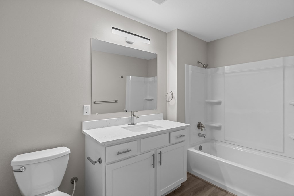 a bathroom with a toilet sink and bathtub in a 555 waverly unit