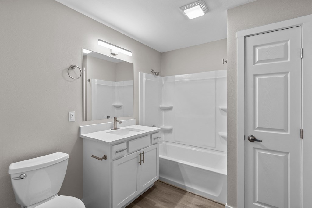 a bathroom with a toilet sink and shower