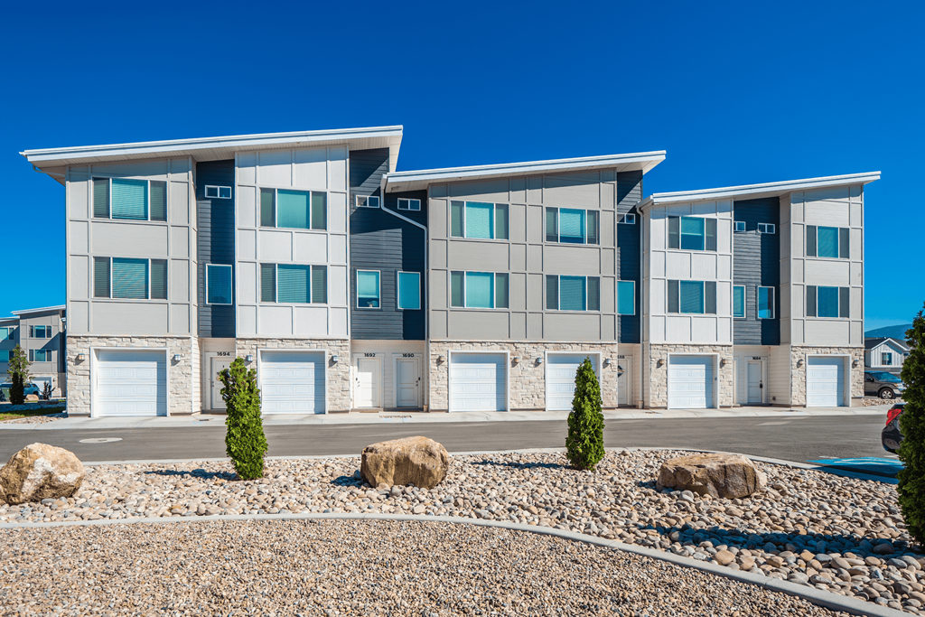Riverwalk Townhomes Exterior Building with Garages and Landscaping