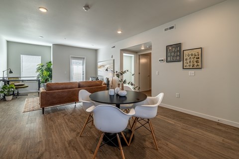 A dining room with a round table and chairs.