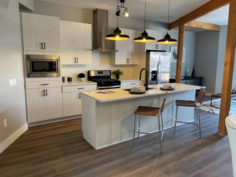 a large kitchen with white cabinets and a counter top
