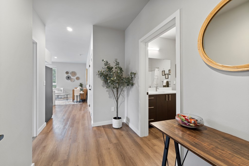 A room with a wooden floor and a mirror on the wall.
