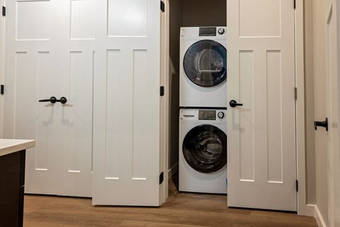A white door with a black handle is open.