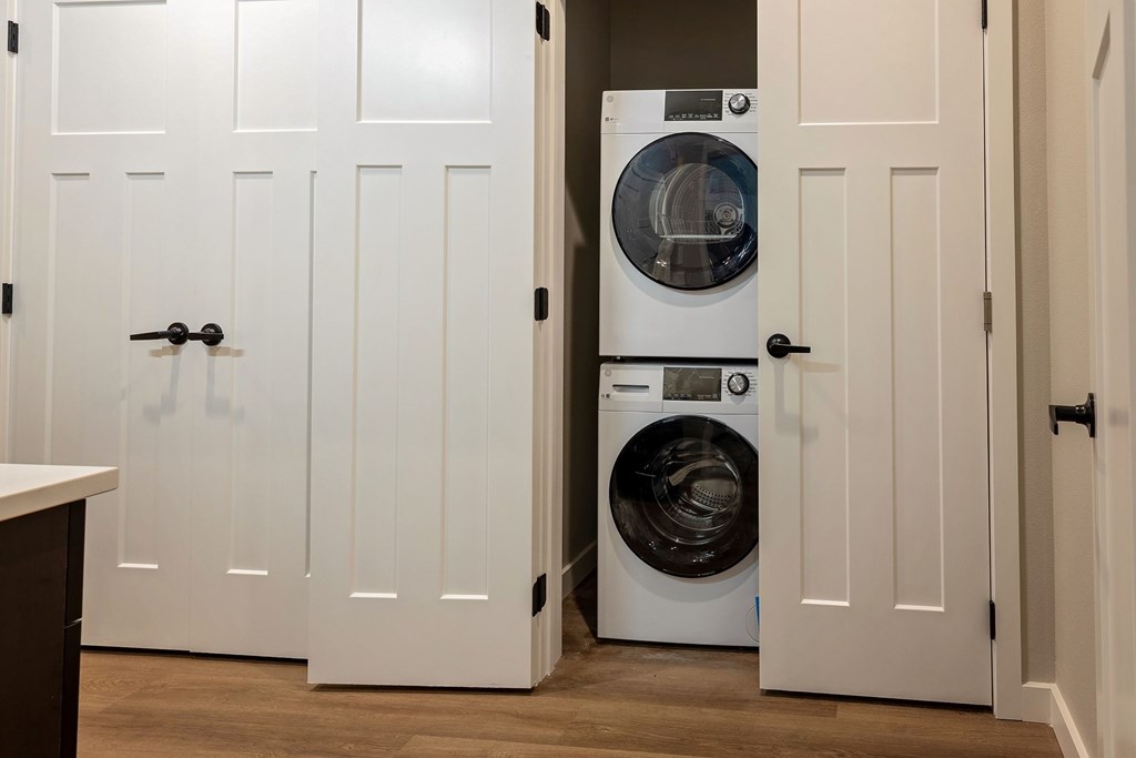 A white door with a black handle is open.