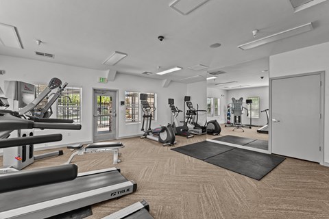 the gym with treadmills and other exercise equipment at the belgard apartments