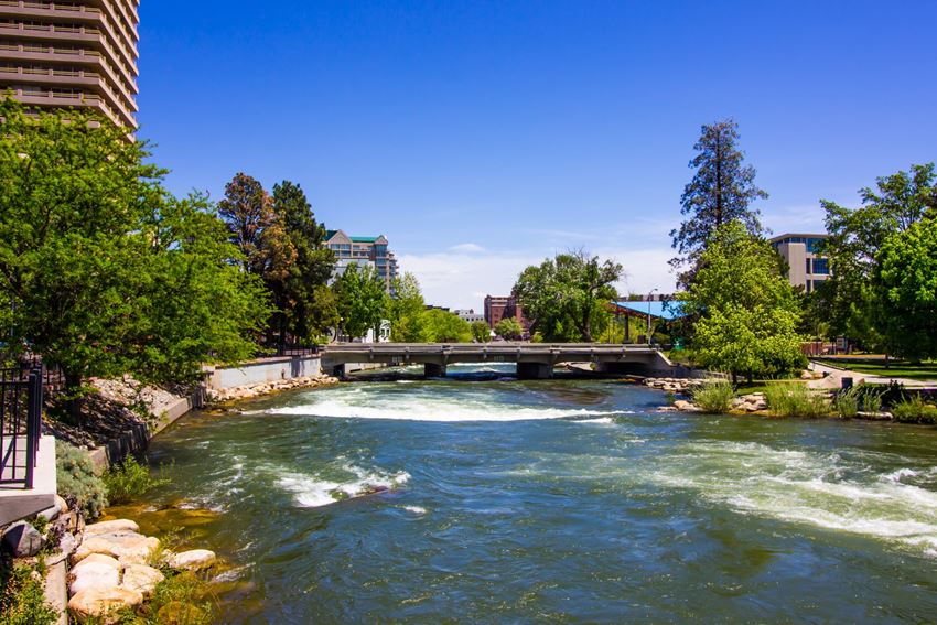 a view of a river flowing under a bridge