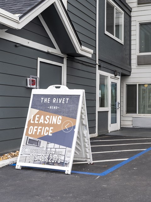 the rivet leasing office sign in front of a building