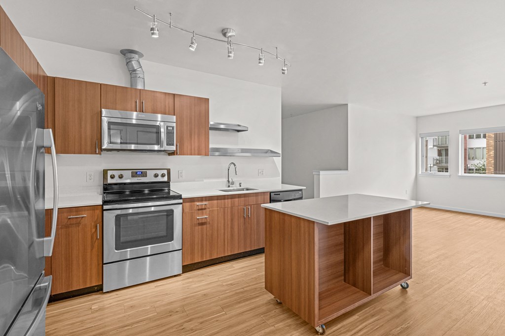 a kitchen with wooden cabinets and stainless steel appliances
