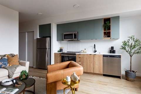 a kitchen and living room with a refrigerator and
