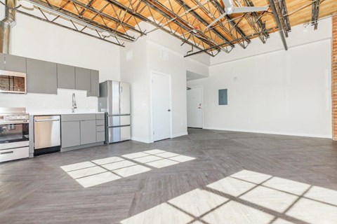 A kitchen with a dining table and a refrigerator.
