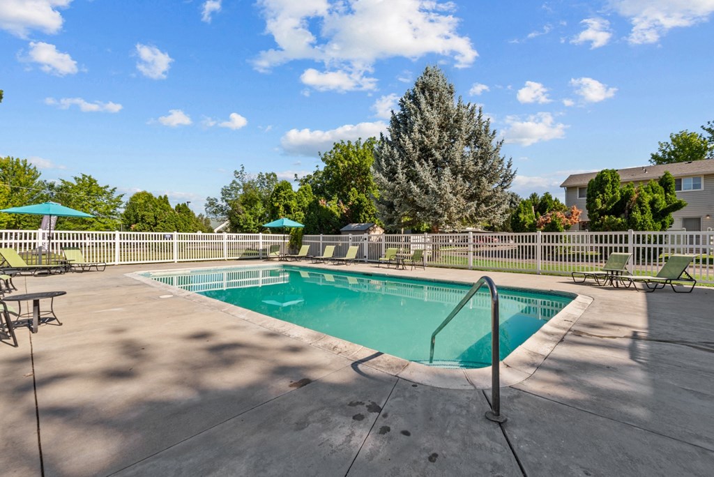 our apartments have a resort style pool with chairs and umbrellas