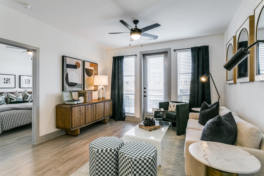 a living room with a couch and a ceiling fan
