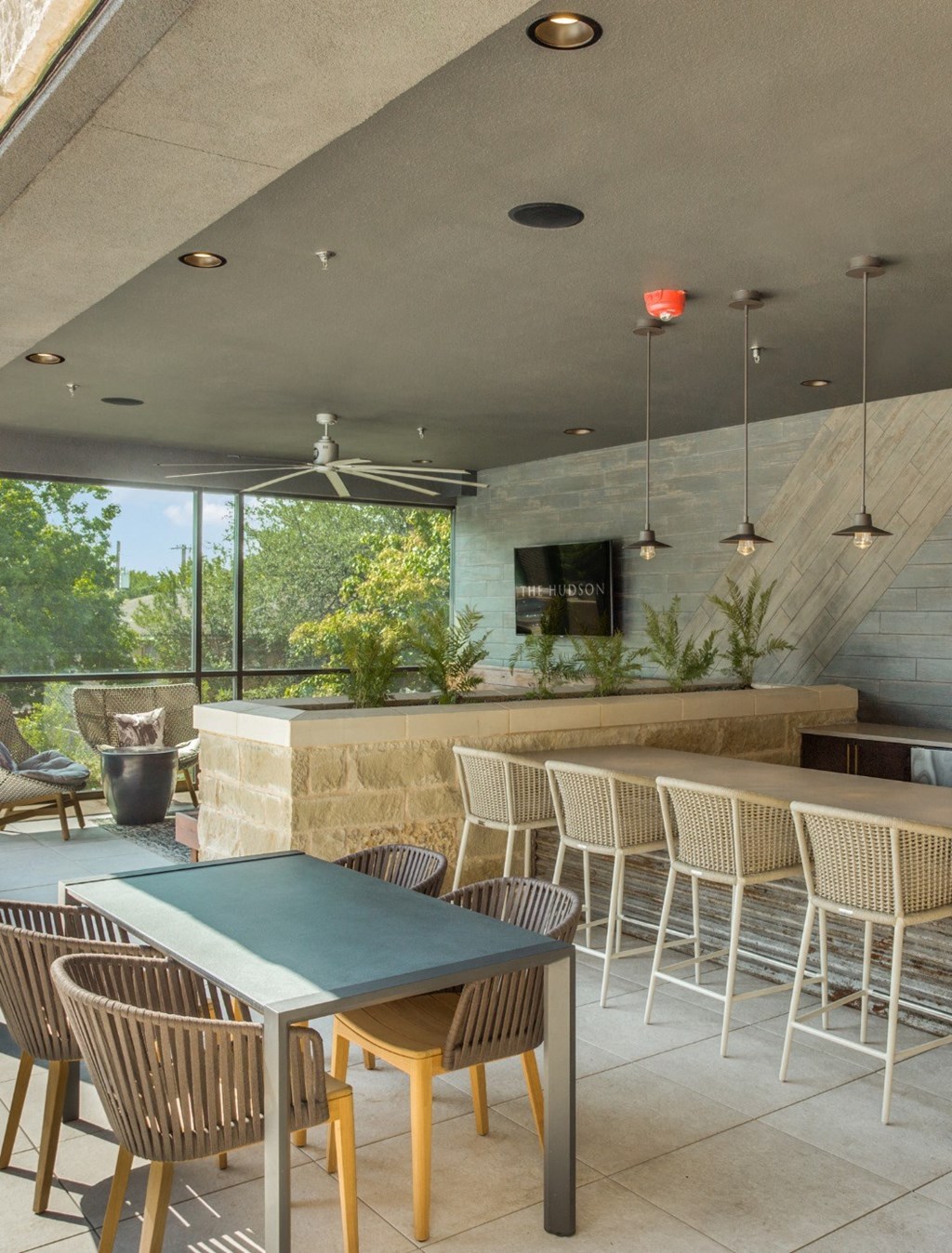 a patio with a table and chairs and a bar