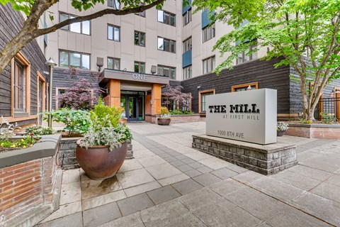front entrance to the mill at first hill with trees and potted plants