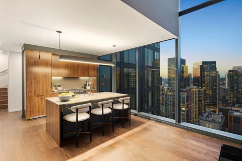 A modern kitchen with a view of the city skyline.