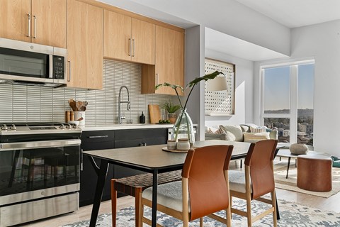 A modern kitchen with a dining table and chairs.