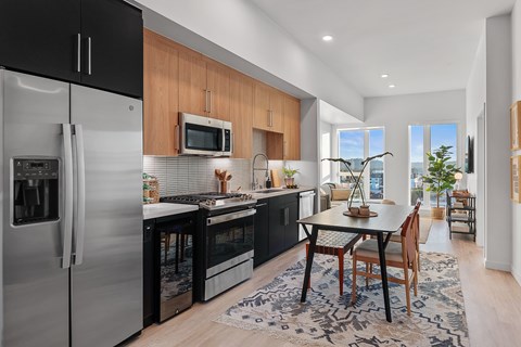 A modern kitchen with a dining table and chairs.
