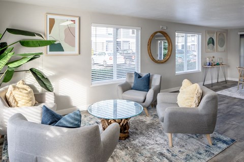 a living room with couches chairs and a table    and a window
