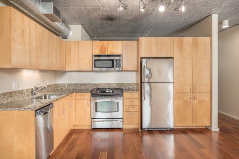 A kitchen with wooden cabinets and stainless steel appliances.