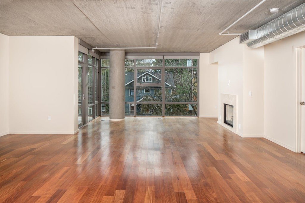 A room with wooden floors and a fireplace.