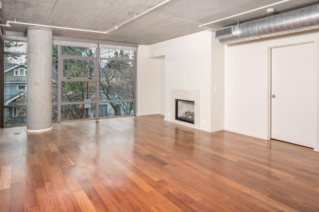 A room with wooden floors and a fireplace.