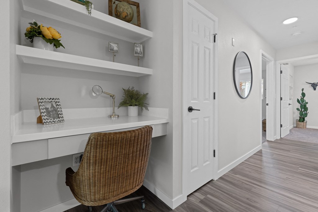 a home office with a desk and a chair