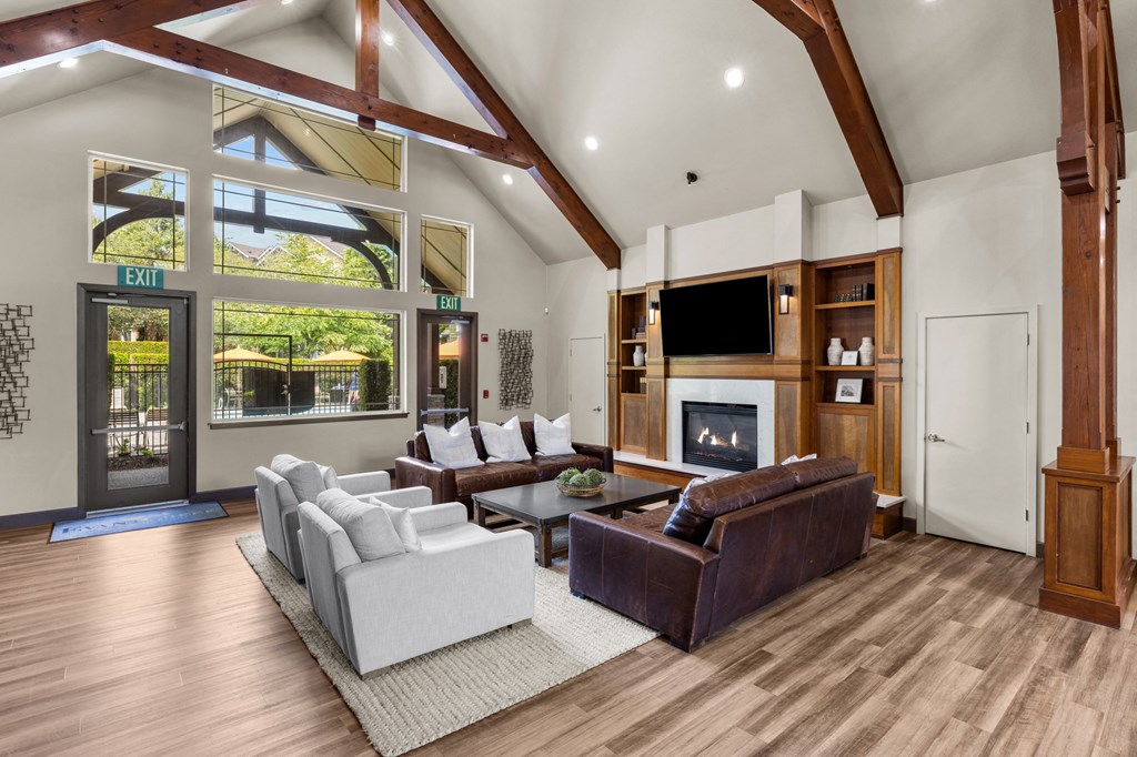 a spacious living room with a vaulted ceiling and a large window with a view of the