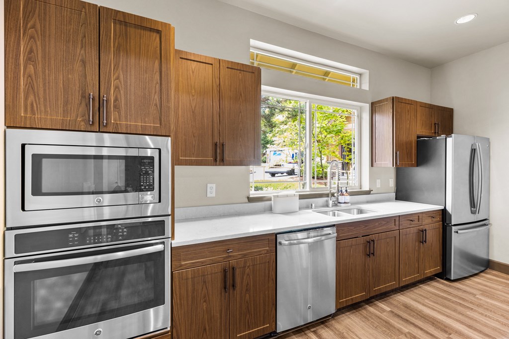 a kitchen with wooden cabinets and stainless steel appliances