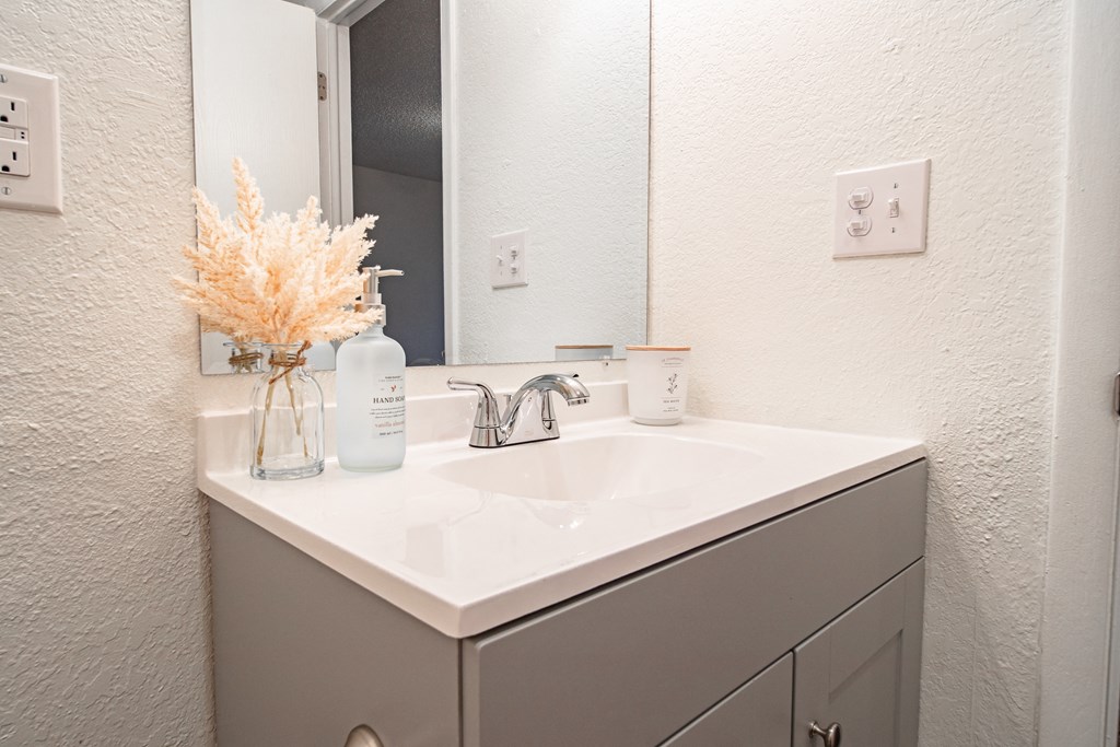 The Willows Apartments bathroom sink and grey cabinets