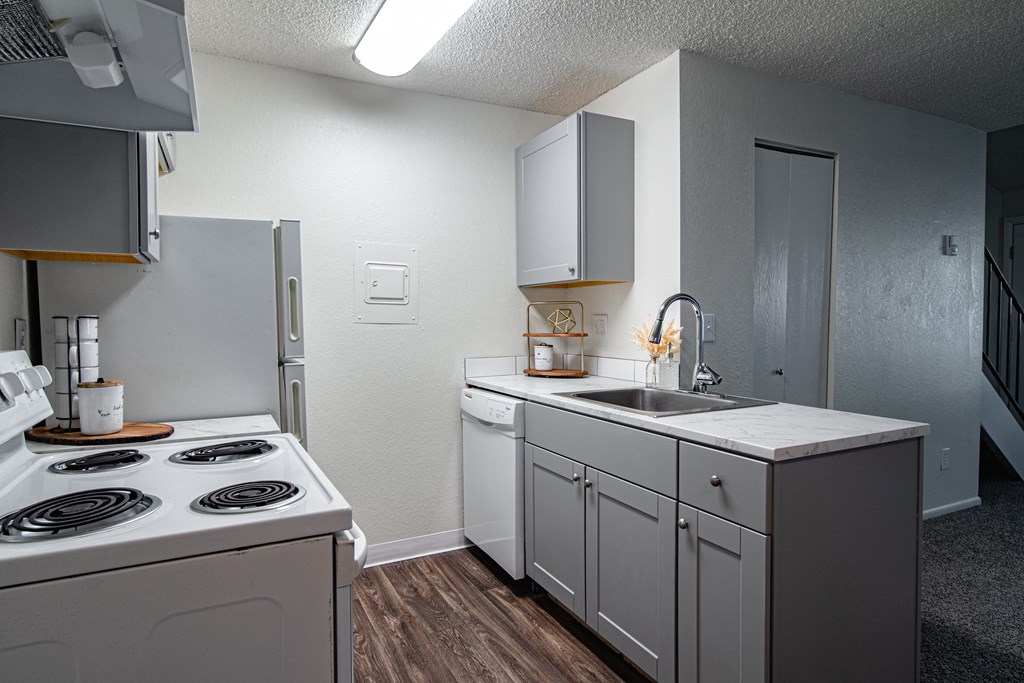 The Willows Apartments kitchen with white appliances and a sink and a refrigerator