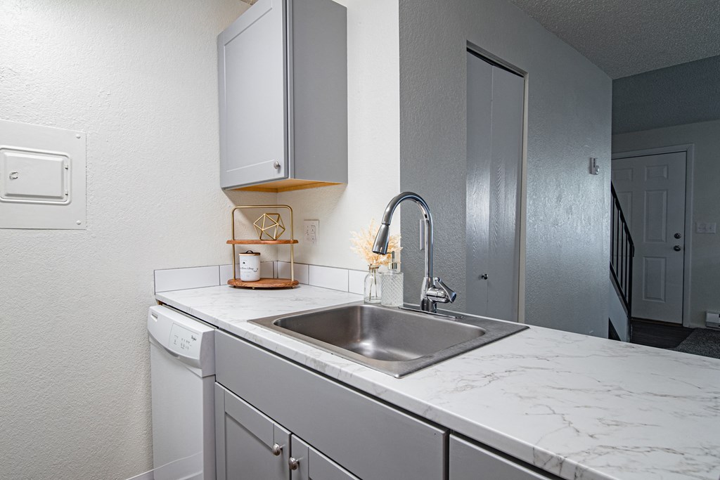 The Willows Apartments kitchen with a sink and white counter tops