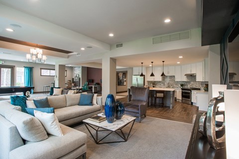 an open living room and kitchen with couches and a table