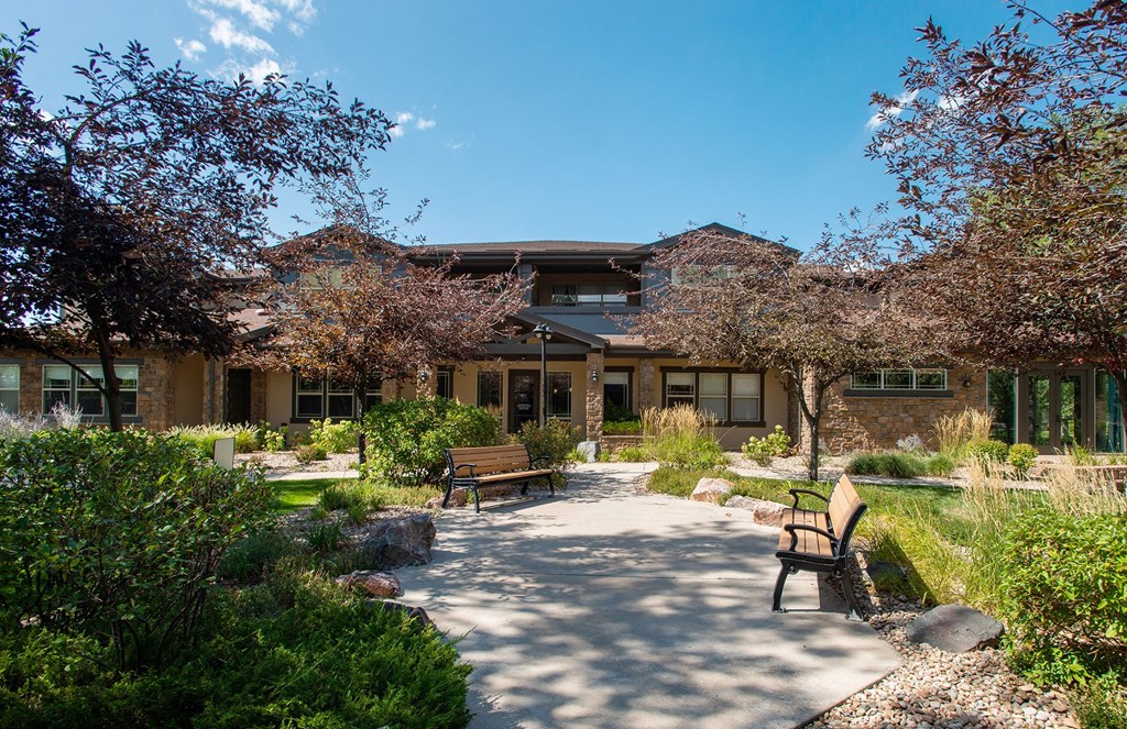Whisper Sky Apartments Exterior Clubhouse and Benches with Landscaping