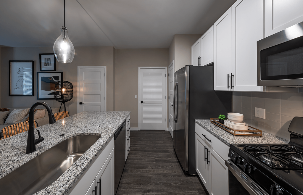 an empty kitchen with granite counter tops and stainless steel appliances