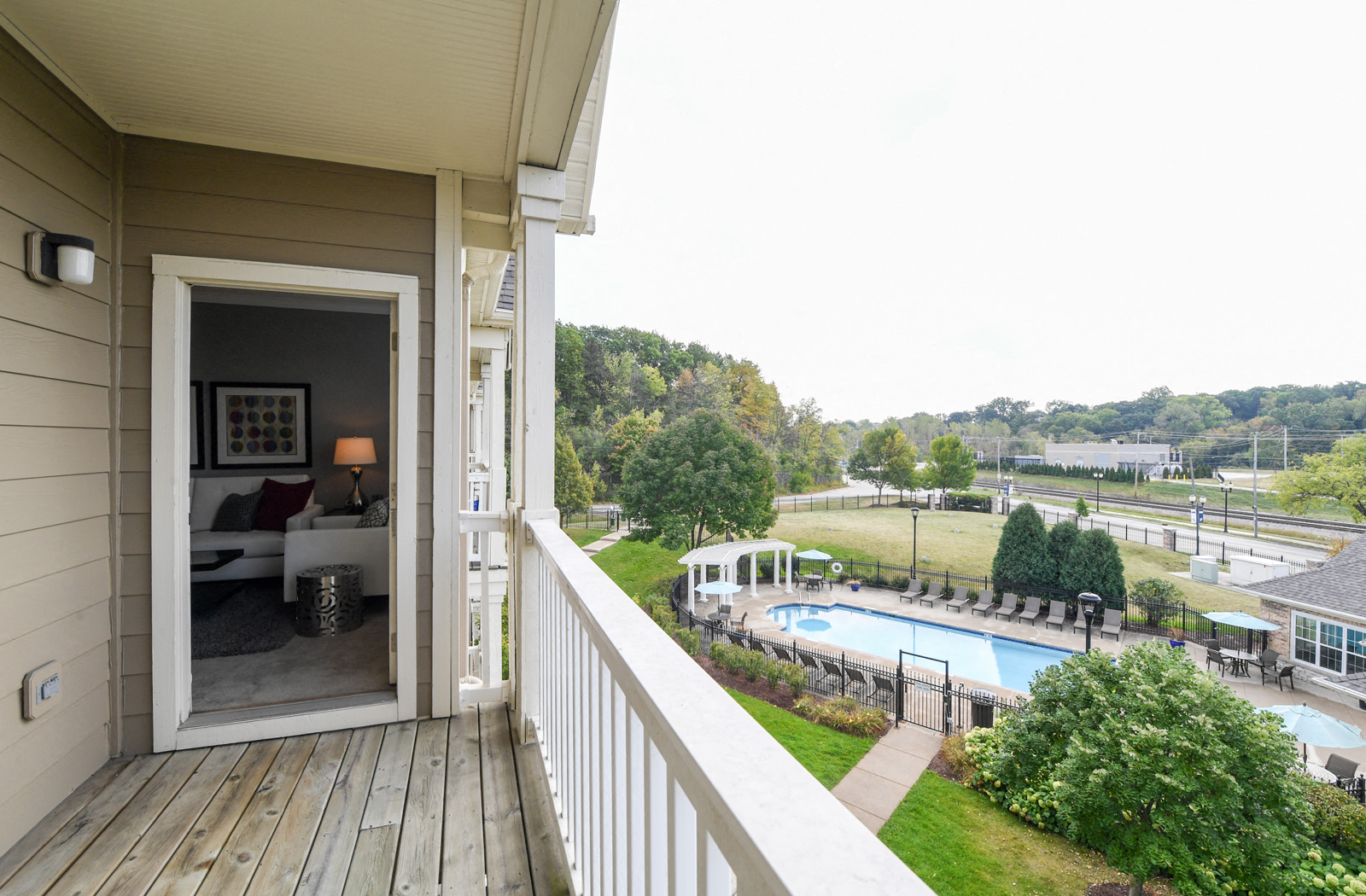 the view from the balcony of a house overlooking a swimming pool