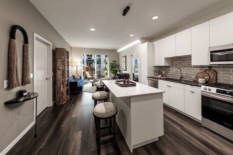 A modern kitchen with white cabinets and a central island.