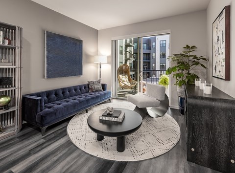 A living room with a blue couch and a coffee table.