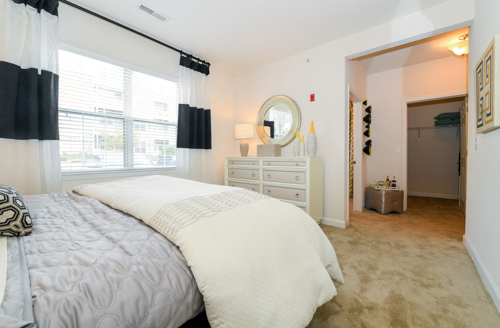 a bedroom with a bed and a dresser and a window