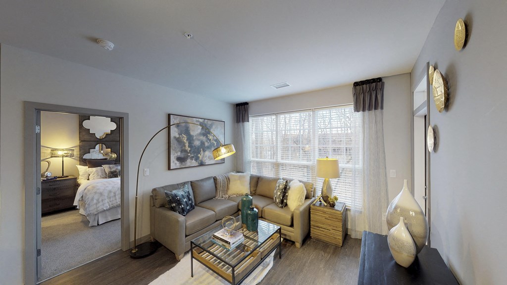 Living room with couches and coffeetable with view of master bedroom.