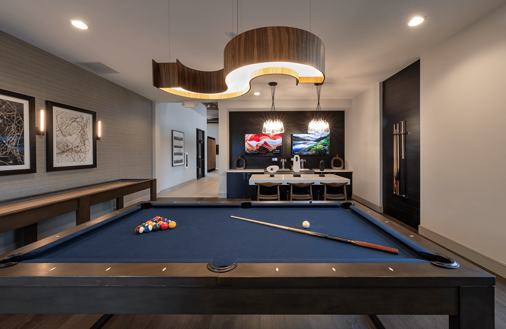 a billiards table in a game room with a blue pool