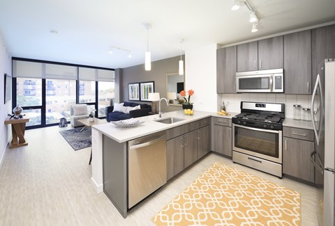 a kitchen with an island and stainless steel appliances