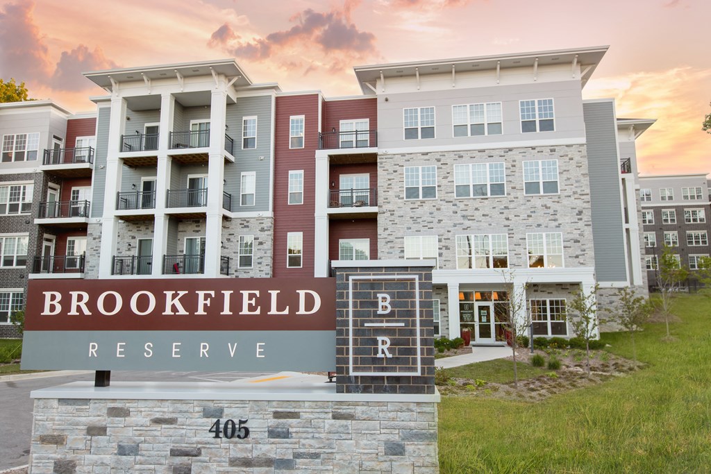 Brookfield Reserve sign in front of the apartment building during sunset.