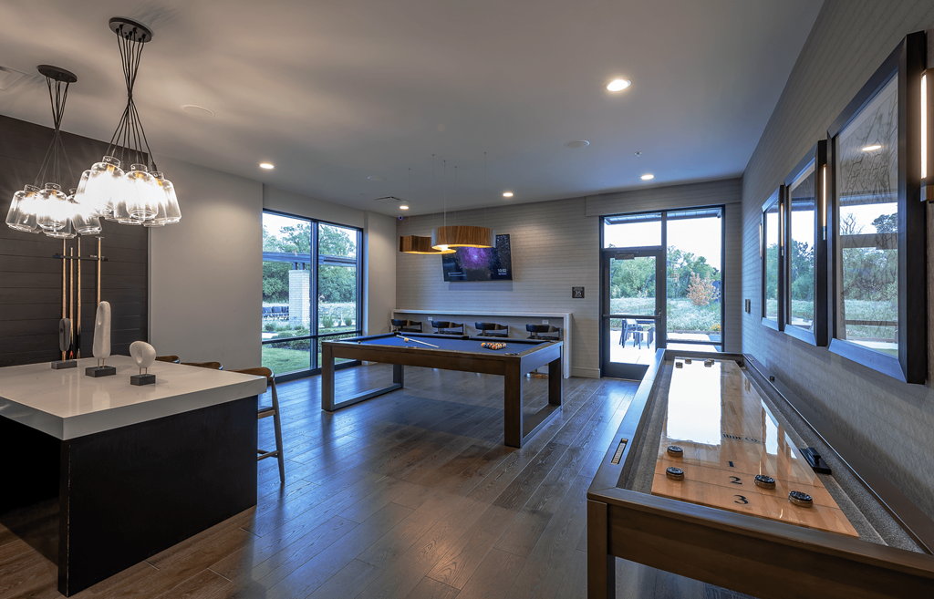 a game room with a pool table and ping pong