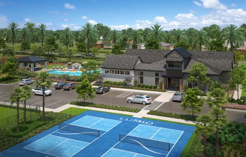 A tennis court is located in front of a house with a pool.