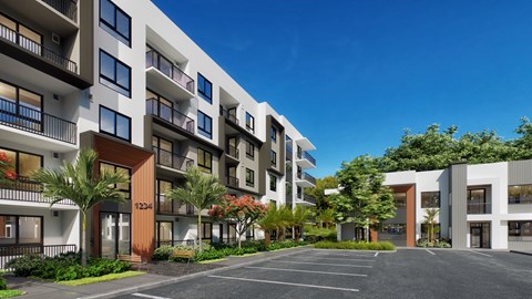 A modern apartment complex with a parking lot in front.
