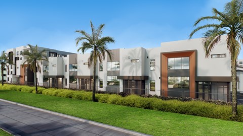 A modern building with a row of palm trees in front.